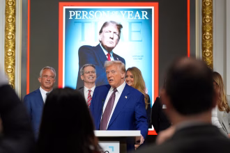 Trump stands at New York Stock Exchange as Time person of the year
